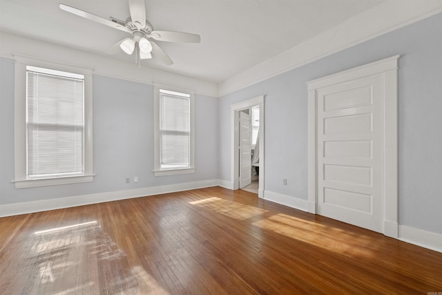 interior space with connected bathroom, ceiling fan, and hardwood / wood-style floors