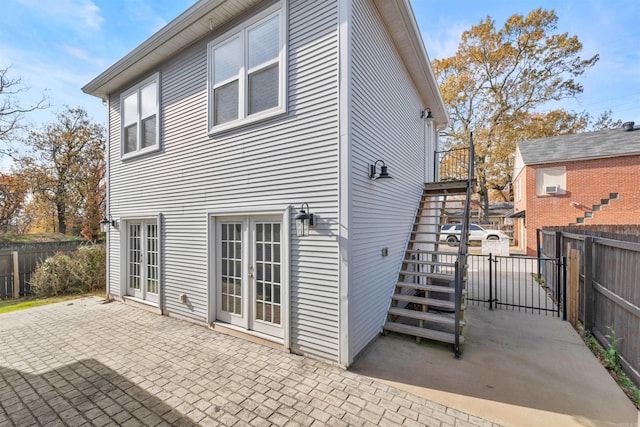 back of property featuring a patio area and french doors