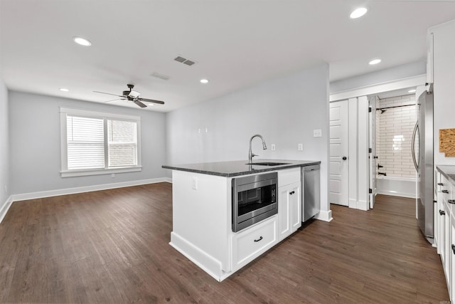 kitchen featuring dark wood-type flooring, white cabinets, sink, ceiling fan, and appliances with stainless steel finishes