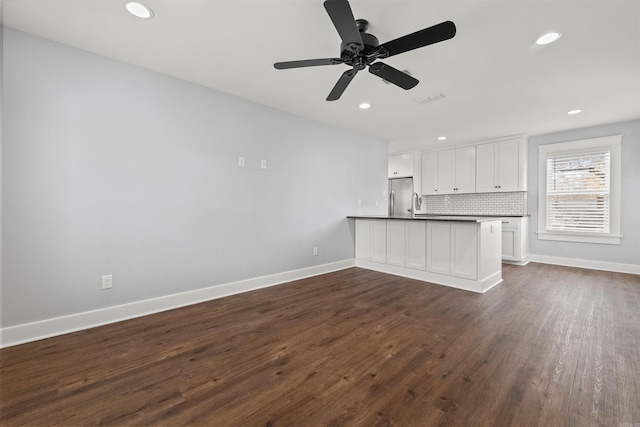 unfurnished living room with ceiling fan and dark wood-type flooring