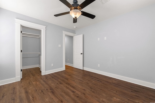 unfurnished bedroom with ceiling fan, a closet, and dark hardwood / wood-style floors