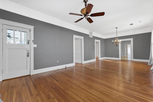 foyer with wood-type flooring and ceiling fan with notable chandelier