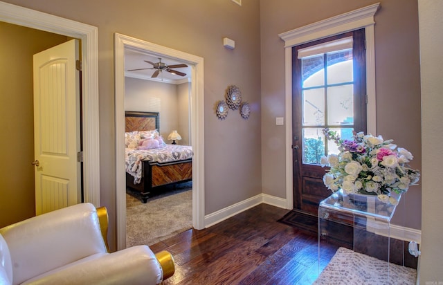 foyer entrance featuring ceiling fan, crown molding, and dark wood-type flooring