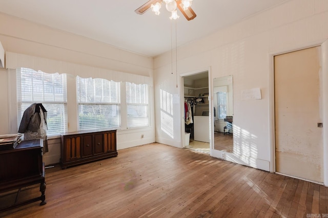 interior space featuring ceiling fan, hardwood / wood-style floors, and washer and dryer