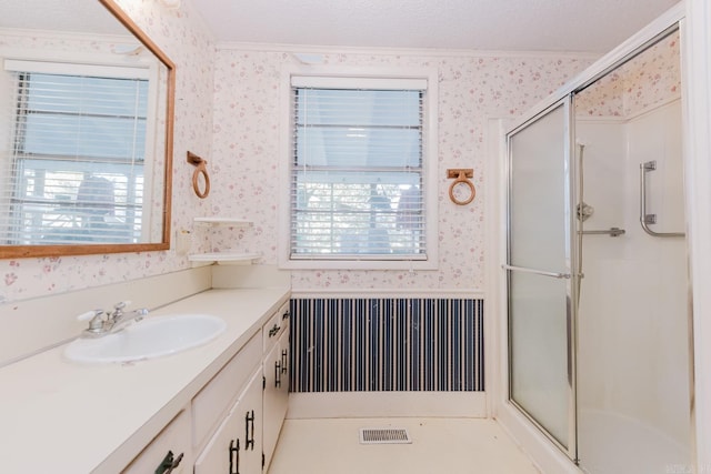 bathroom featuring an enclosed shower, a healthy amount of sunlight, and a textured ceiling