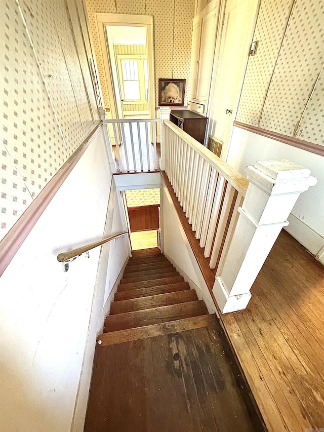 stairs featuring hardwood / wood-style flooring