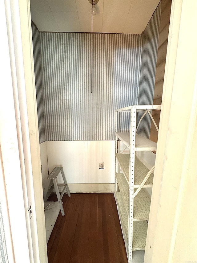 hallway with dark hardwood / wood-style flooring