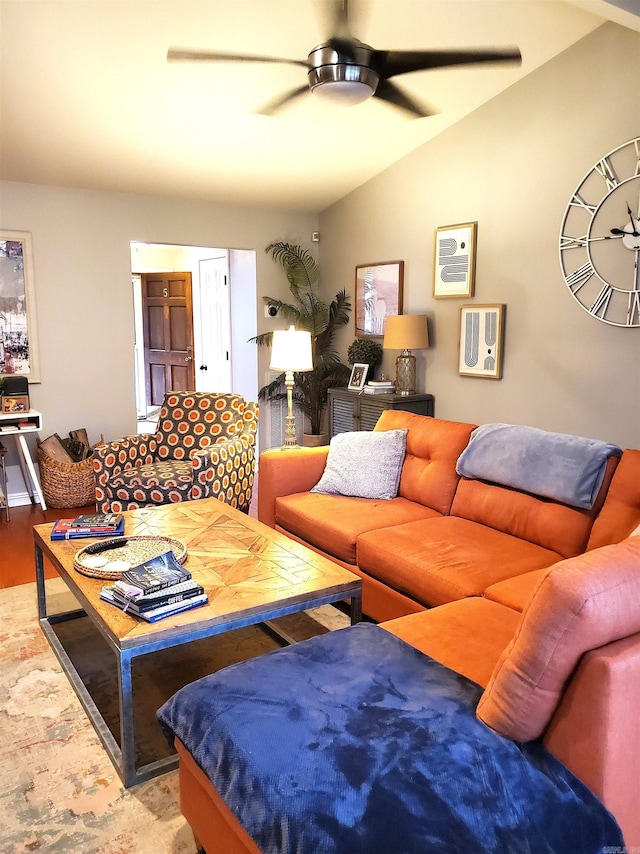 living room featuring ceiling fan, wood-type flooring, and lofted ceiling