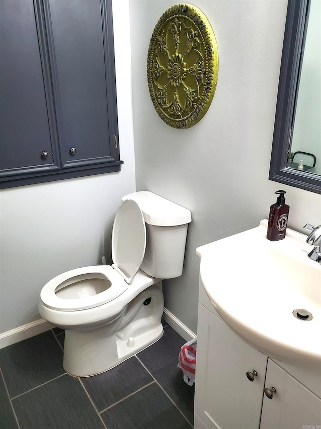 bathroom featuring tile patterned floors, vanity, and toilet