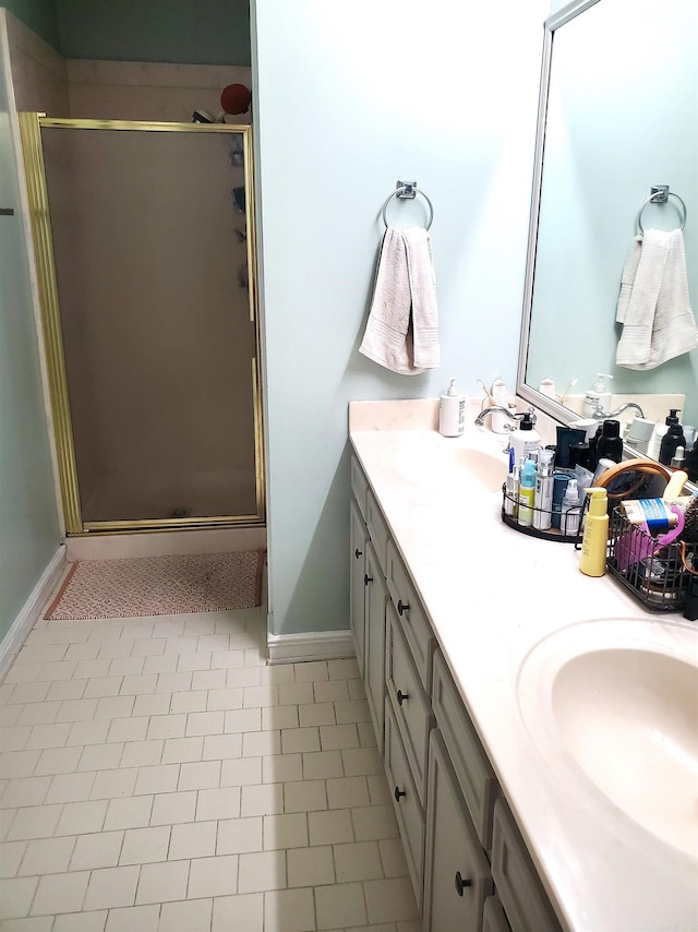 bathroom with vanity, tile patterned floors, and a shower with shower door