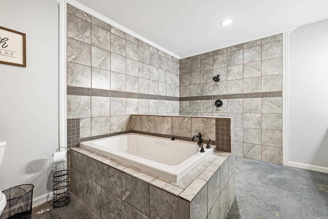 bathroom with toilet, ornamental molding, and tiled bath