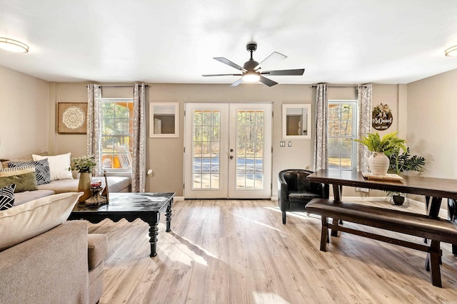 living room with ceiling fan, light wood-type flooring, and french doors