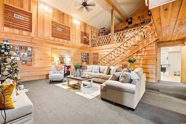 living room featuring wood walls, high vaulted ceiling, carpet flooring, ceiling fan, and beam ceiling