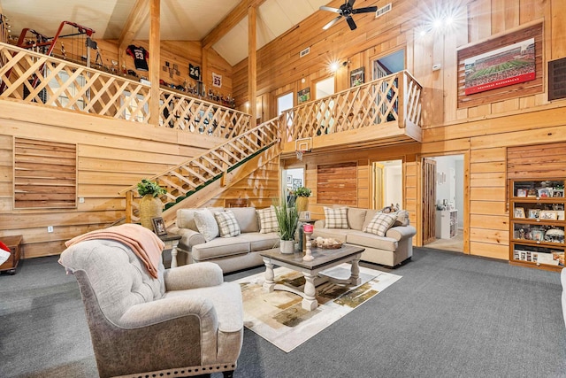 living room with carpet, ceiling fan, beamed ceiling, and high vaulted ceiling