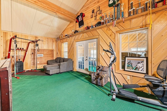 workout room featuring carpet flooring, lofted ceiling, wooden walls, and french doors