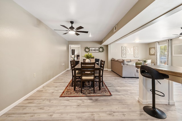 dining space featuring light wood-type flooring and ceiling fan