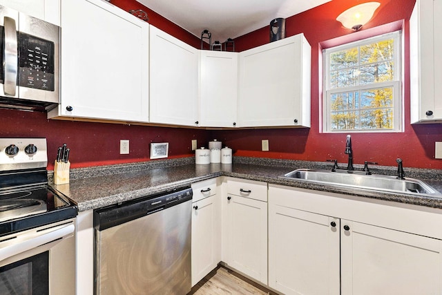 kitchen featuring white cabinetry, sink, and appliances with stainless steel finishes