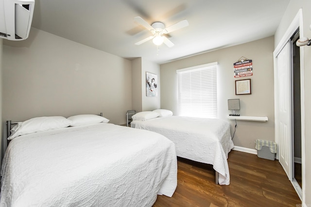 bedroom featuring ceiling fan, a closet, and dark hardwood / wood-style floors