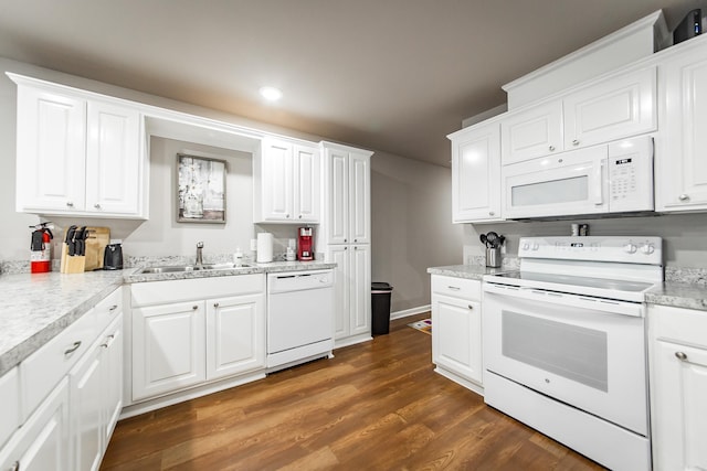 kitchen with white cabinetry, dark hardwood / wood-style flooring, white appliances, and sink