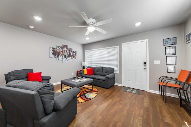 living room with wood-type flooring and ceiling fan