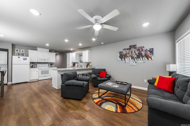 living room with dark hardwood / wood-style floors and ceiling fan