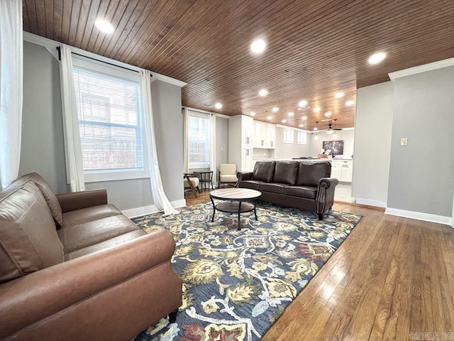 living room featuring light hardwood / wood-style flooring, wooden ceiling, and ornamental molding