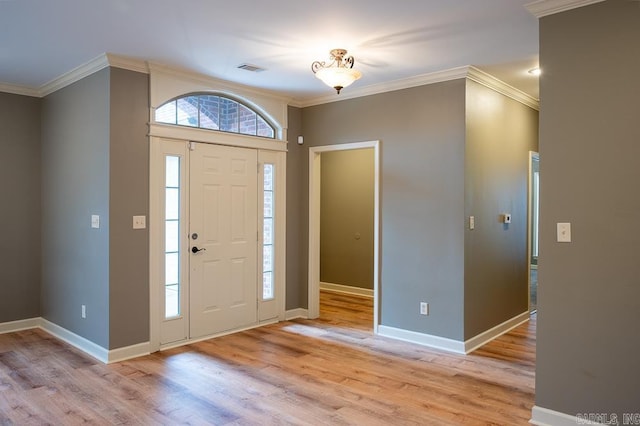 foyer entrance with light hardwood / wood-style floors and crown molding