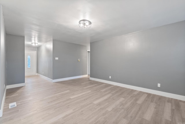 empty room with light hardwood / wood-style floors