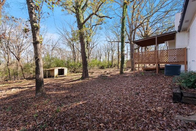 view of yard featuring central air condition unit and a shed