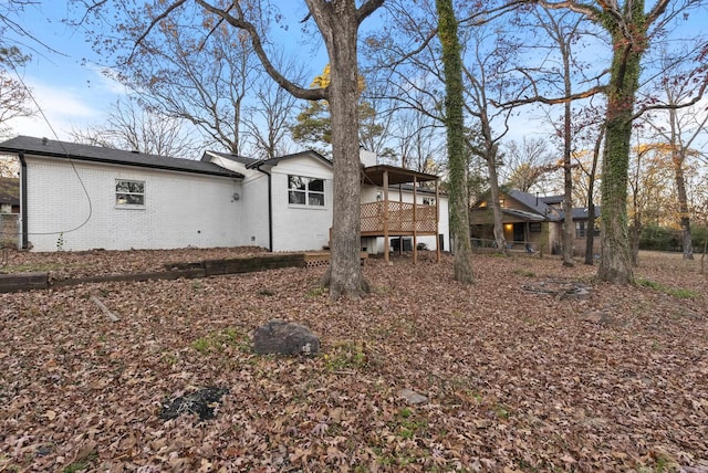 rear view of house featuring a deck