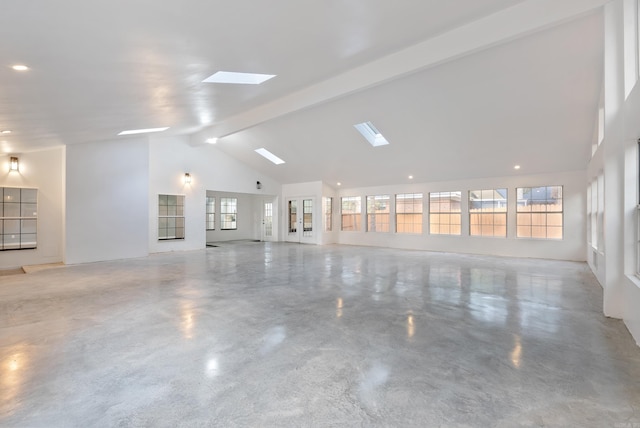 unfurnished room with beamed ceiling and high vaulted ceiling