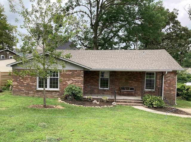 single story home with a porch and a front lawn