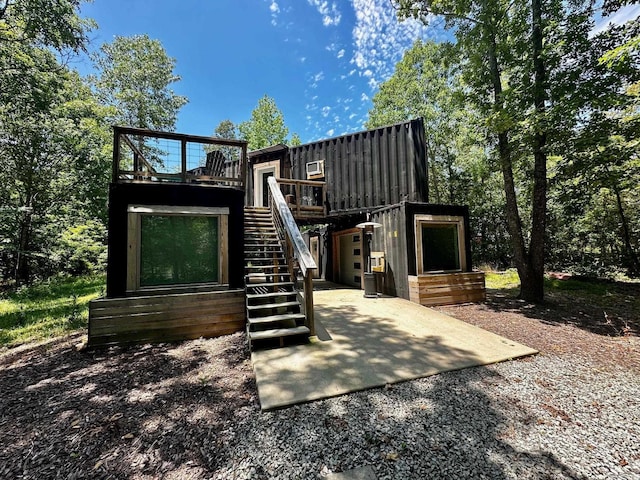 rear view of property featuring a deck