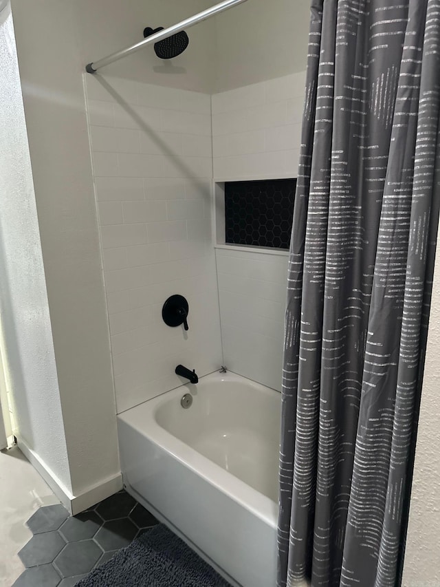 bathroom featuring tile patterned flooring and shower / tub combo with curtain