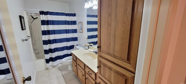 full bathroom featuring shower / bath combo with shower curtain, tile patterned flooring, vanity, and toilet