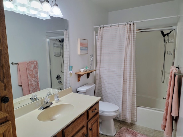 full bathroom with tile patterned floors, shower / bath combo with shower curtain, vanity, and toilet