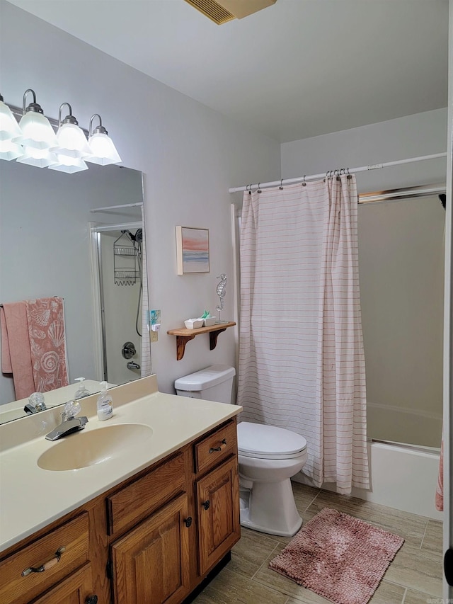 full bathroom featuring vanity, shower / bath combo, and toilet