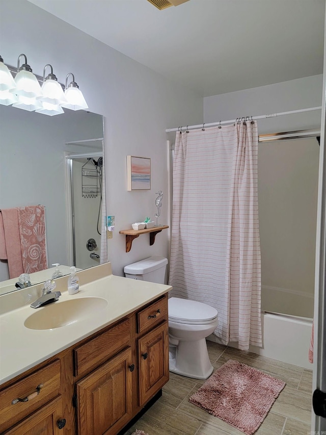 full bathroom with shower / tub combo, vanity, and toilet