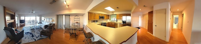 interior space with light hardwood / wood-style flooring, ceiling fan, and lofted ceiling