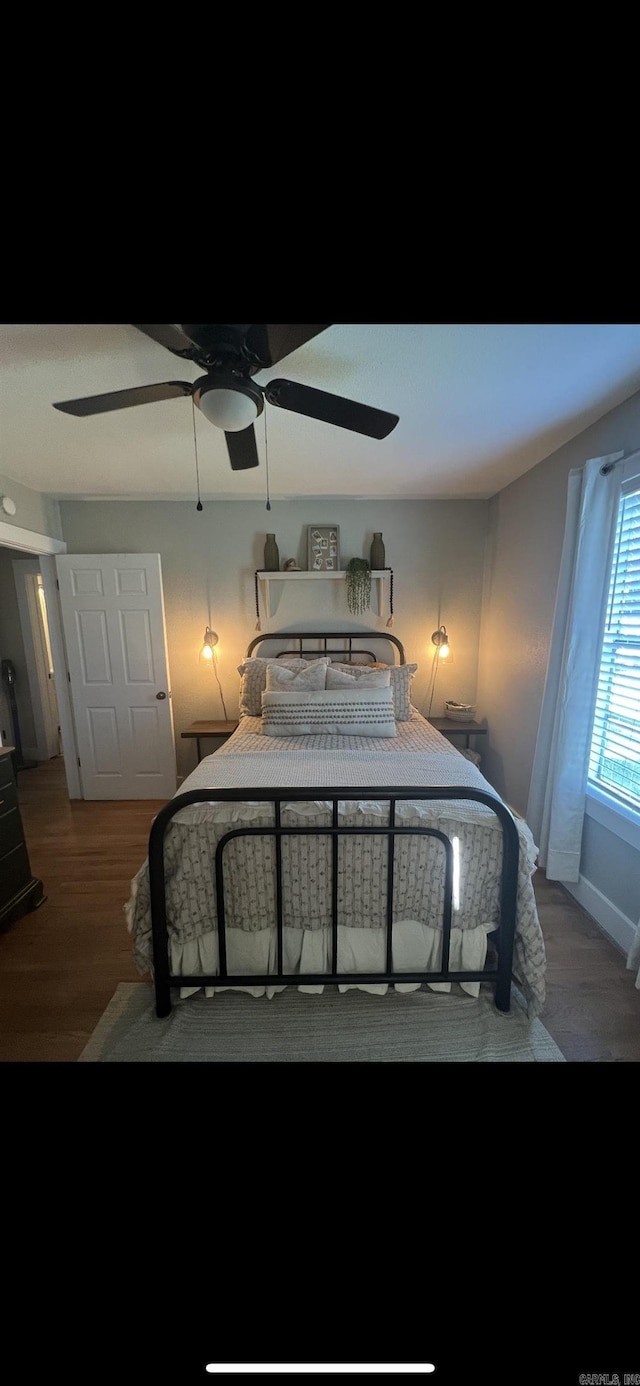 bedroom featuring dark hardwood / wood-style floors and ceiling fan