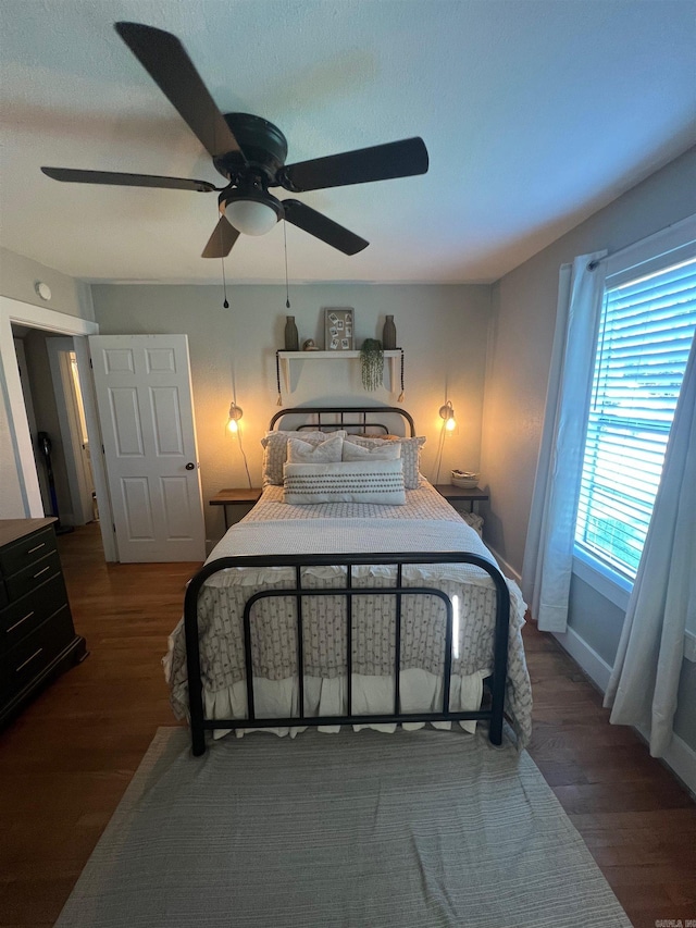 bedroom with ceiling fan and dark hardwood / wood-style floors