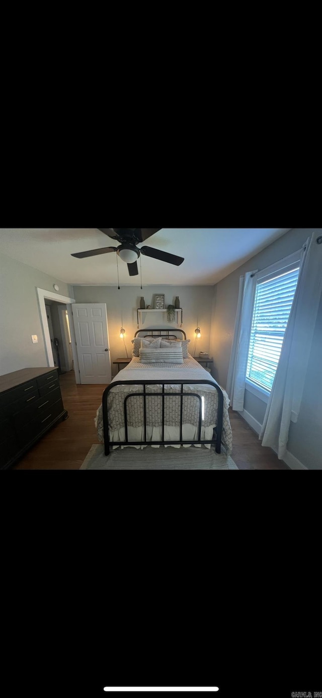 bedroom with ceiling fan and dark wood-type flooring