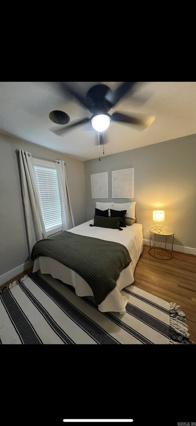 bedroom with hardwood / wood-style floors and ceiling fan