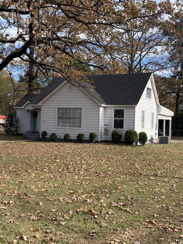 exterior space with a lawn and a sunroom