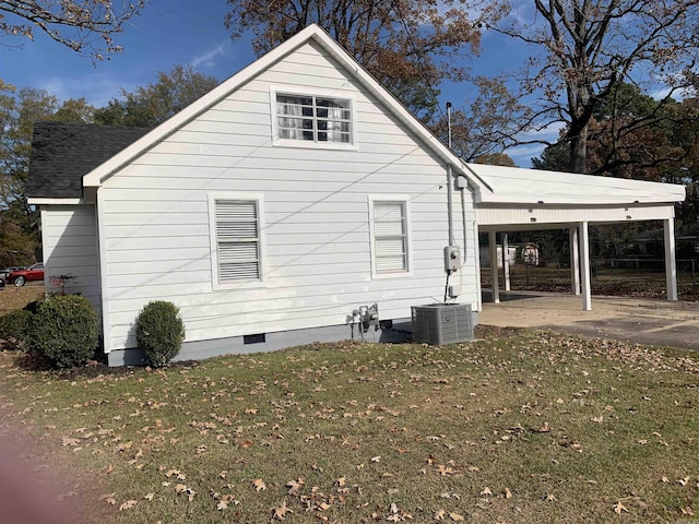 view of side of home featuring a yard, central AC unit, and a carport