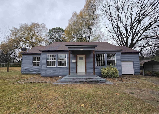 view of front of house with a garage, a front yard, and a carport