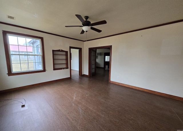 empty room with ceiling fan, dark hardwood / wood-style flooring, and ornamental molding