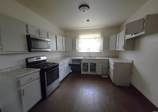 kitchen featuring sink, white cabinetry, dark wood-type flooring, and appliances with stainless steel finishes