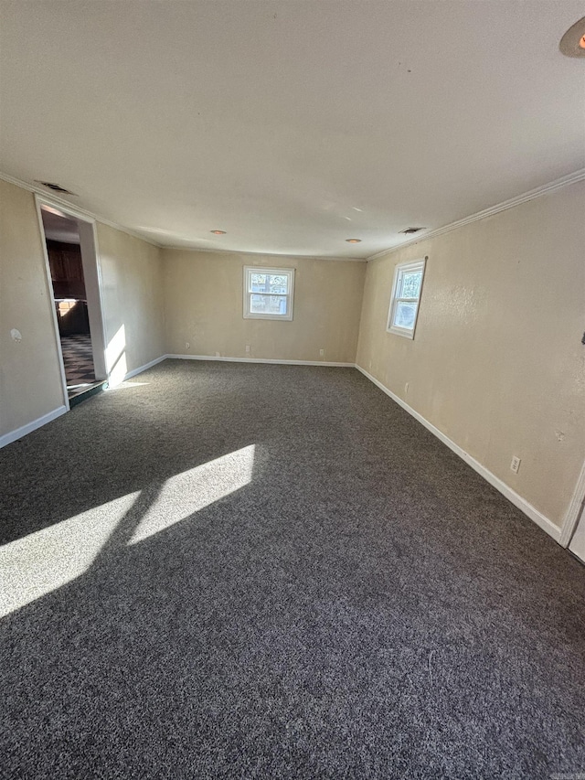 carpeted spare room featuring crown molding