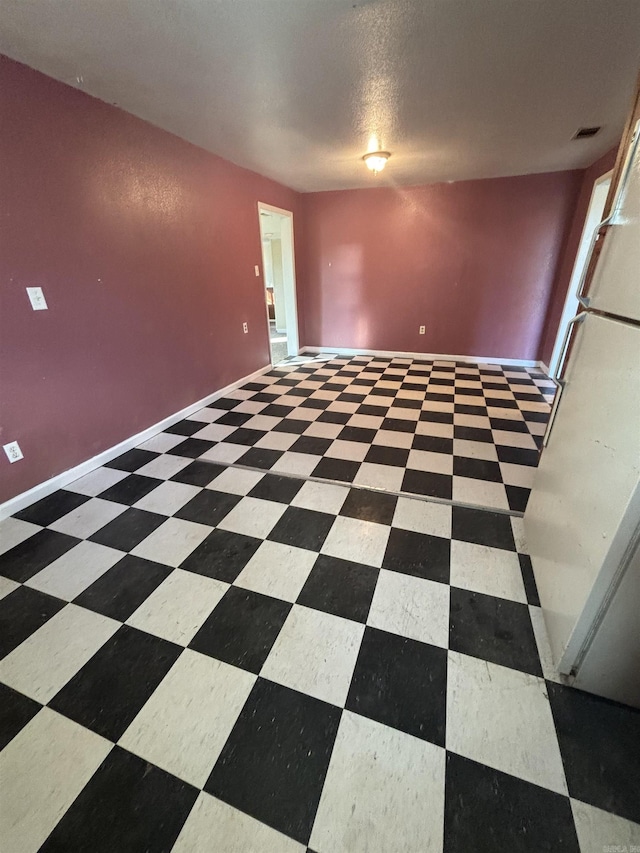 unfurnished room featuring a textured ceiling